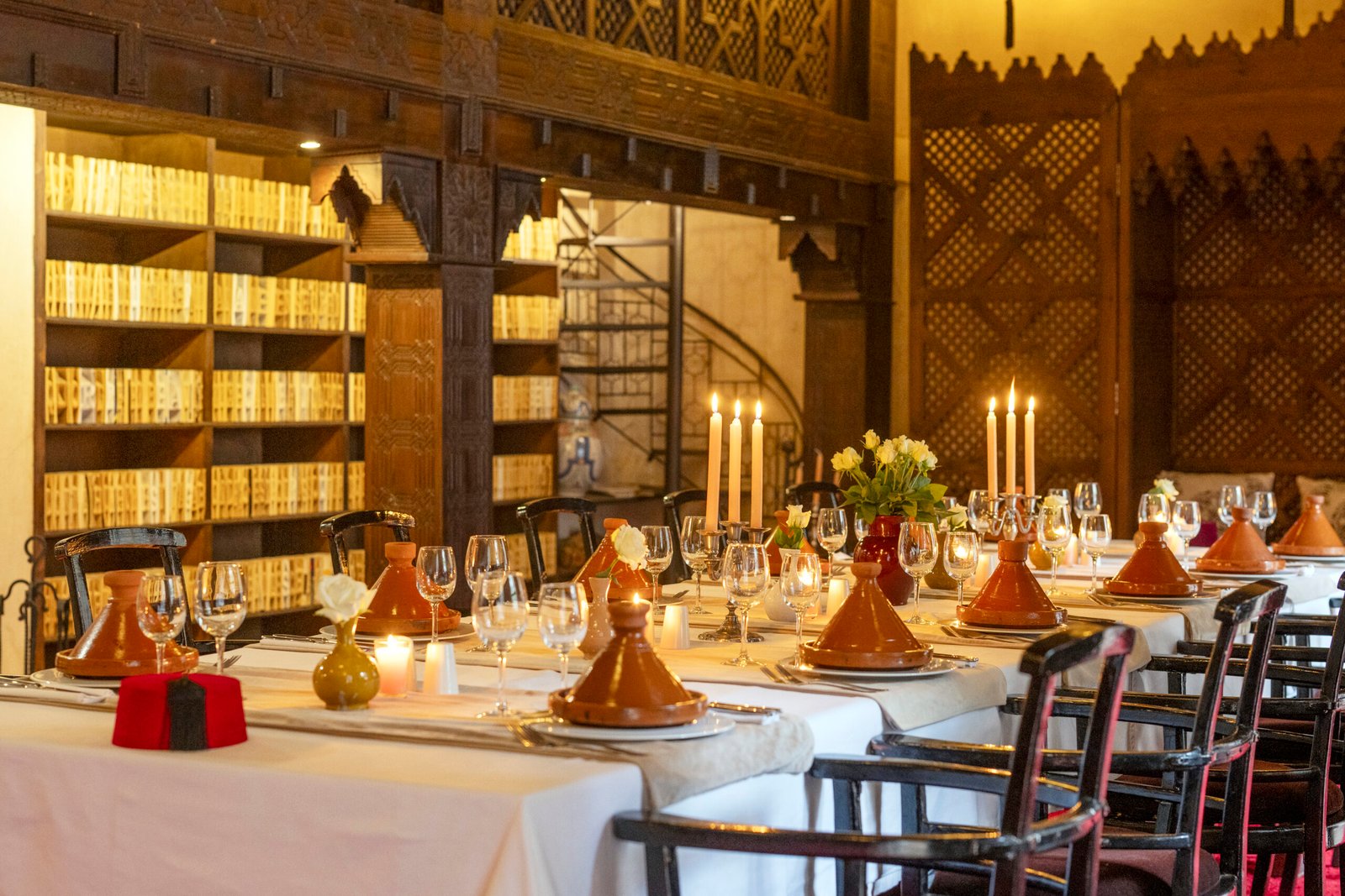 Elegant Moroccan dining table with tajines and candles at Almaha Marrakech restaurant in the Kasbah
