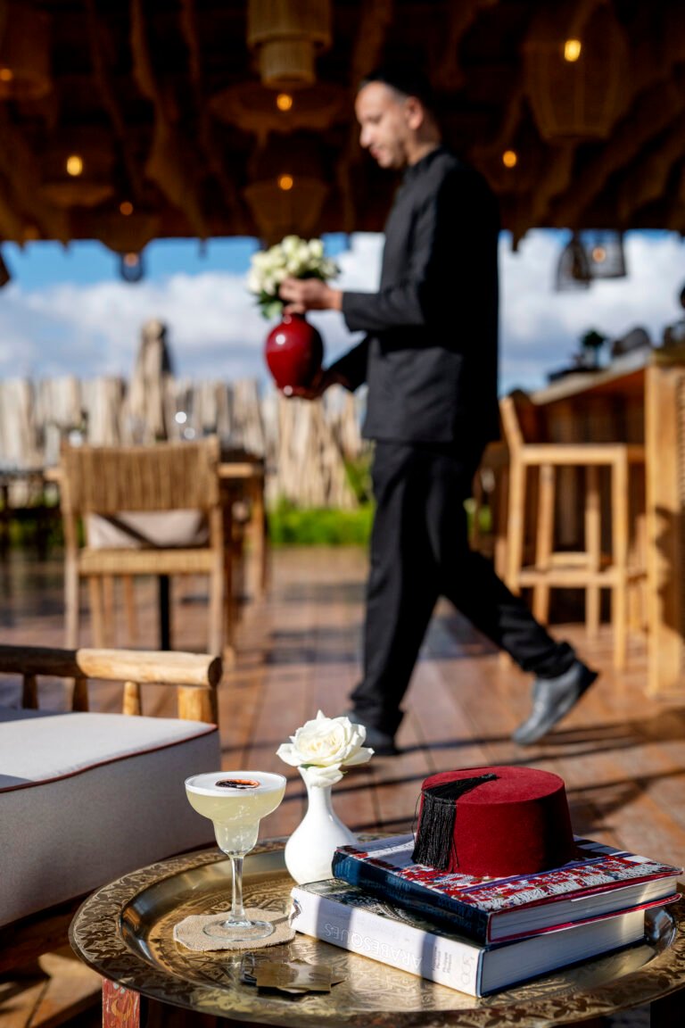 Breathtaking panoramic view of the snow-capped Atlas Mountains from the shaded rooftop terrace at Almaha Marrakech