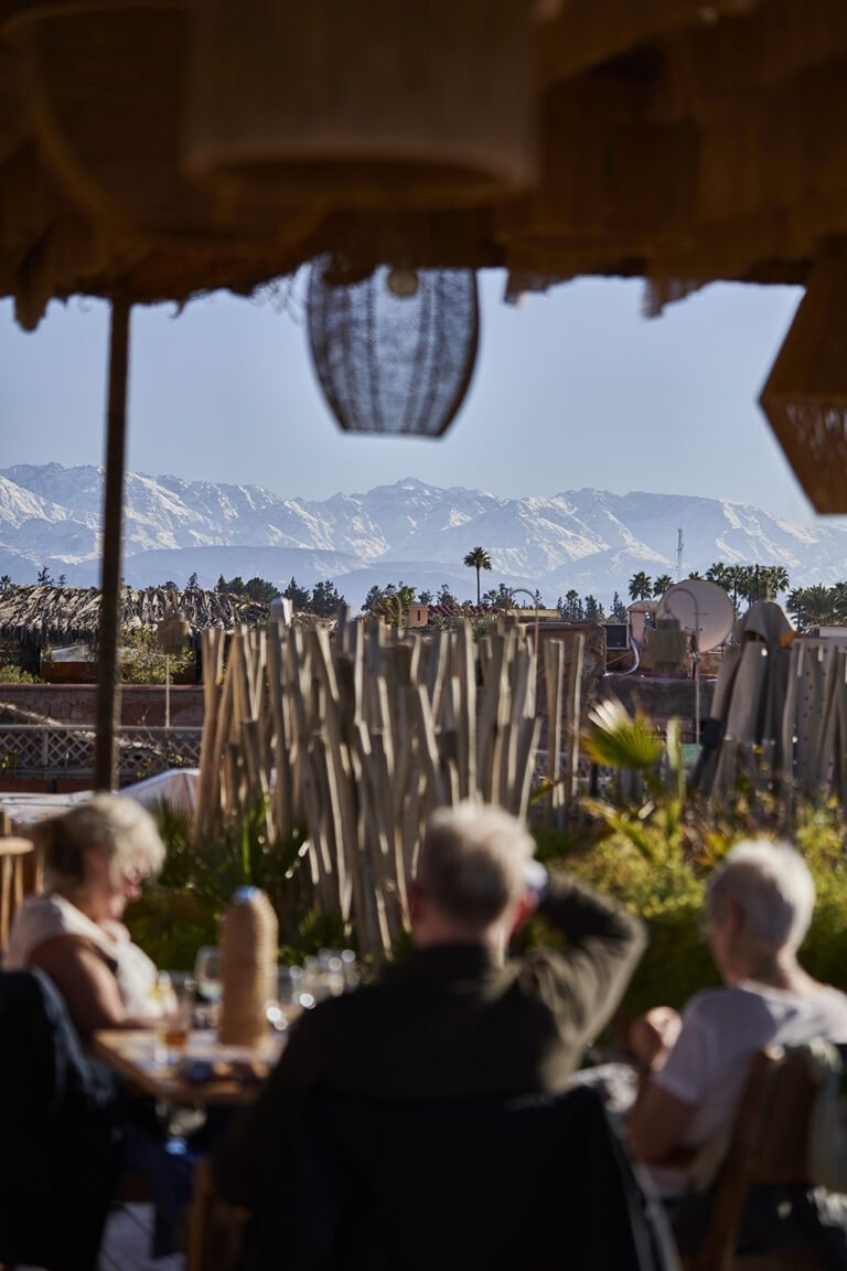 Panoramic view of the snow-capped Atlas Mountains from the Bidaya rooftop bar at Almaha Marrakech