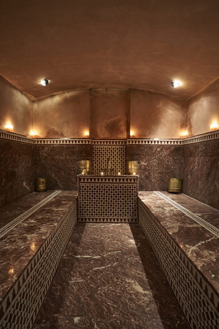 Traditional Moroccan hammam steam room with marble and zellige tiles at Les Bains Almaha Marrakech